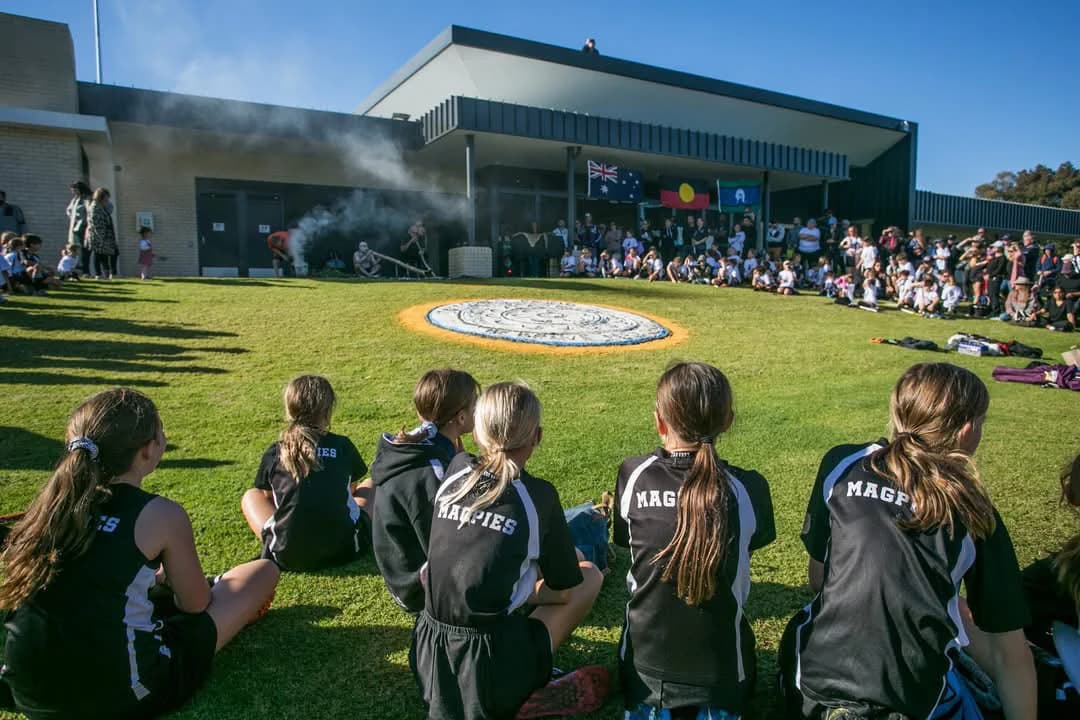 Junior Magpies watching a smoking ceremony at the club